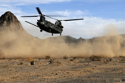 Helicopter landing with rotor blades in motion