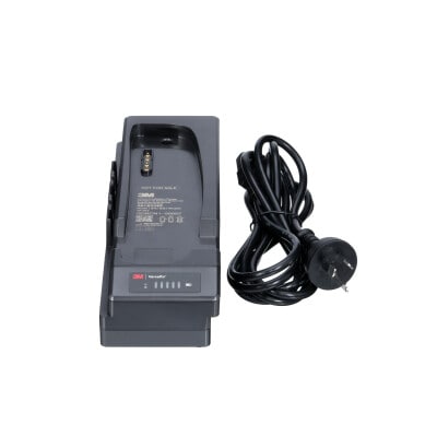 A 3M Versaflo Single Station Battery Charger Kit TR-642A beside power cord