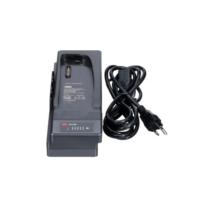 A 3M Versaflo Single Station Battery Charger Kit TR-642N beside power cord