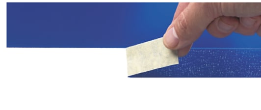 image of thumb pulling masking tape