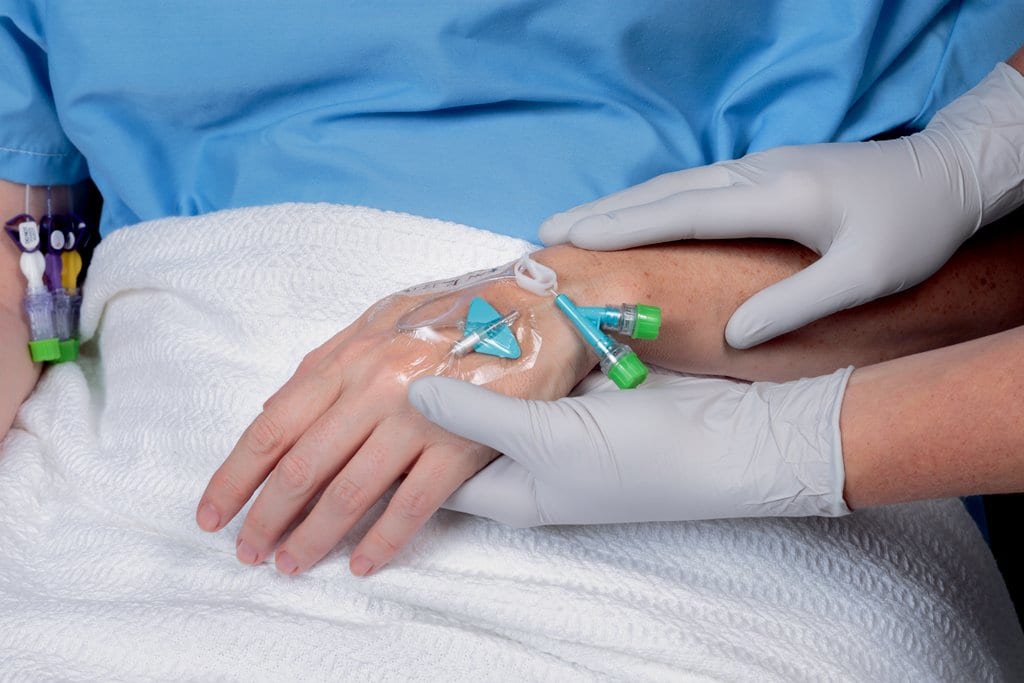 Image of PVAD being secured on a patient.  