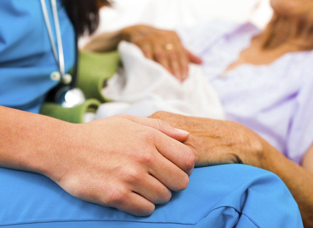 Caring Nurse Holding Hands