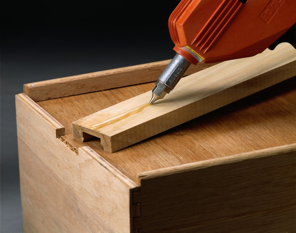 Structural adhesive being applied to a piece of wood