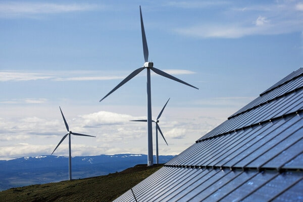 A landscape featuring wind turbines and solar panels, symbolizing renewable energy sources.