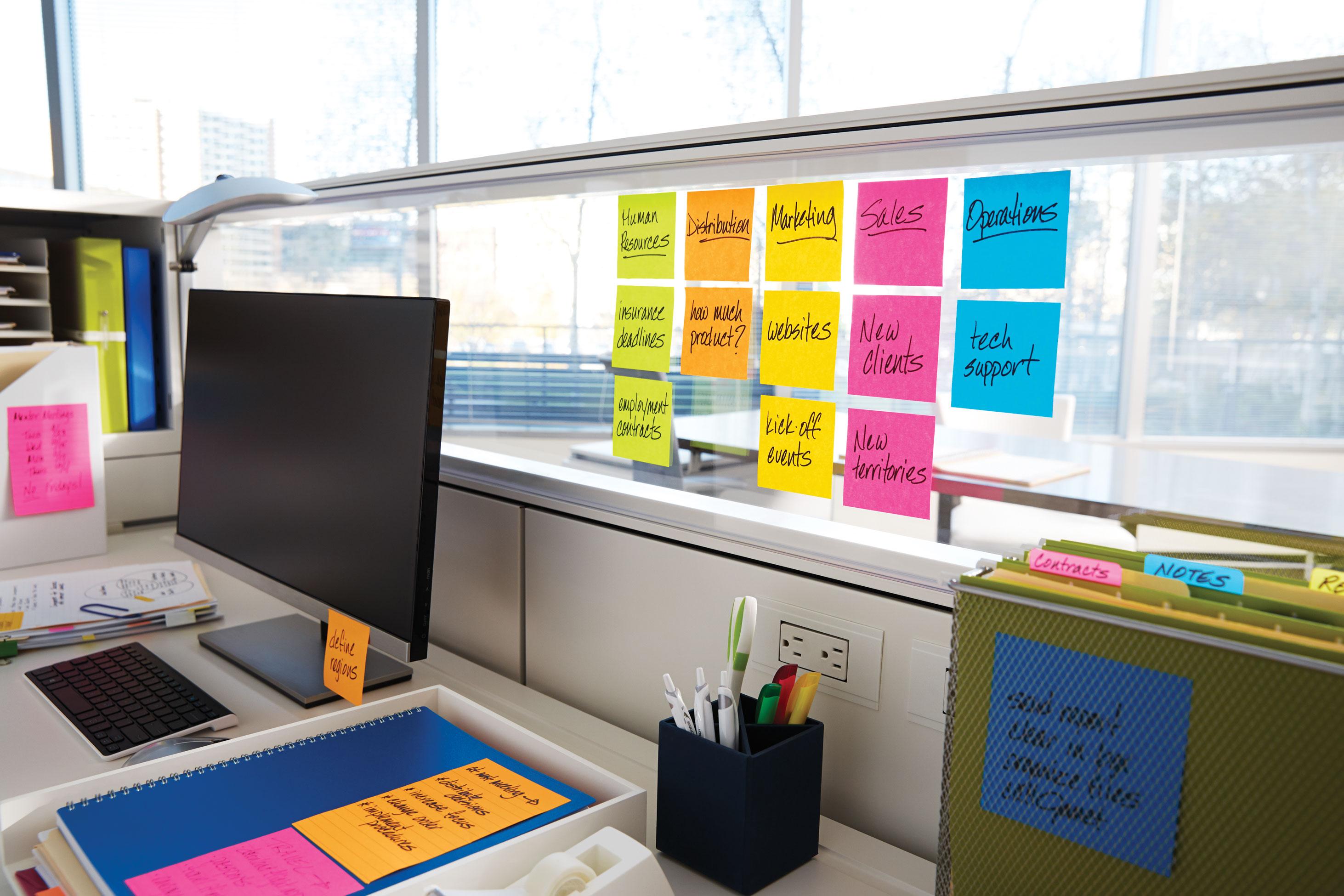 Post-its on an office cubicle