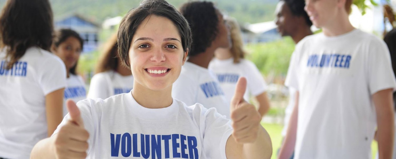 happy volunteer girl showing thumbs up