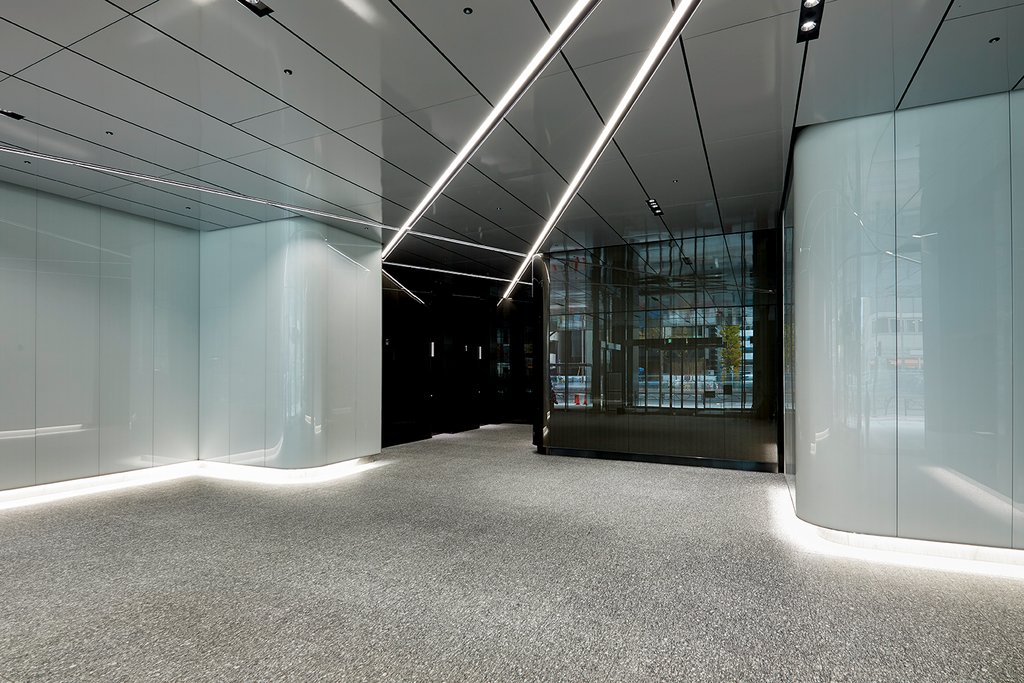 Inside of a building with glass, contoured walls and LED lighting