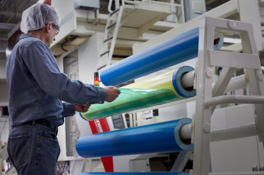 Image of a worker removing a flexographic plate from a
                flexographic plate on a cylinder