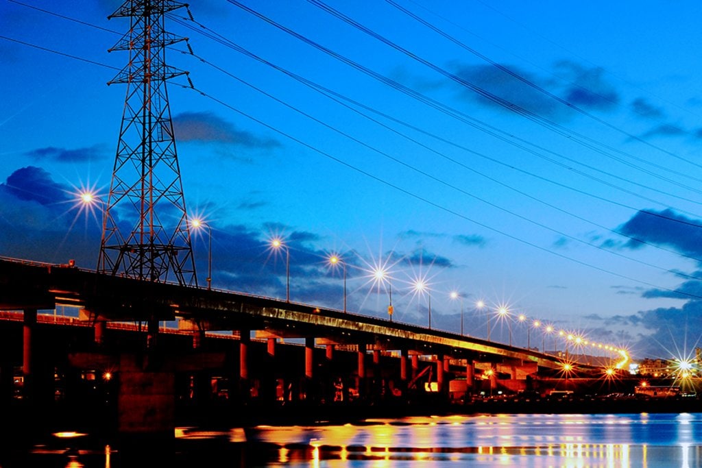 powerline at night by bridge