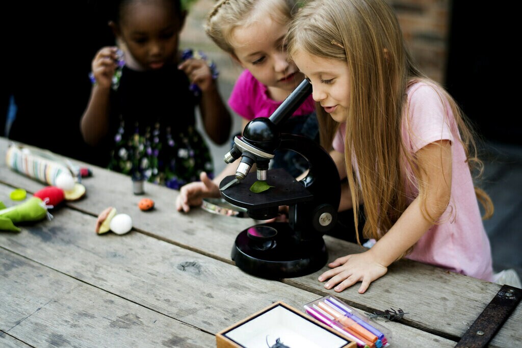 Group of children running science experiments.