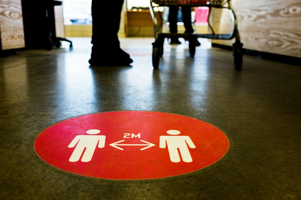 Physical distancing graphic sign on the floor.