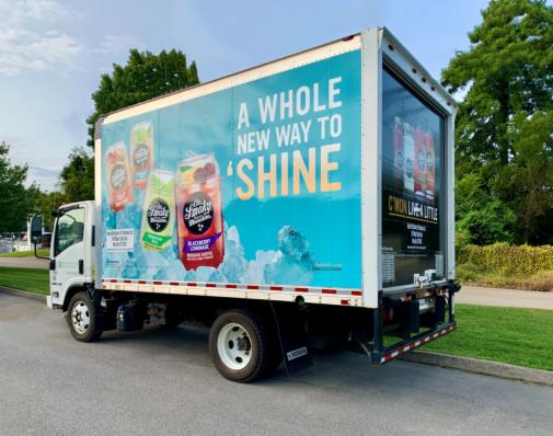 Image of installation of Ole Smoky Moonshine box truck wrap for Empire Distributing