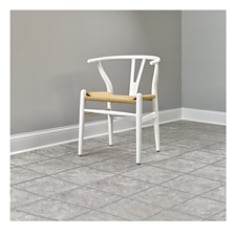 White chair on a tiled floor with Scotch Glides on the four feet of the chair.