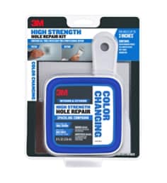 Image of the packaging for the Color Changing 3M™ High Strength Hole Repair Kit for interior and exterior use. Use for dents, dings and small repairs. Applies blue, dries white. Blue, White and black in color. Kit includes an eight ounce tub of color changing spackle, putty knife, self adhesive patch and a sanding pad