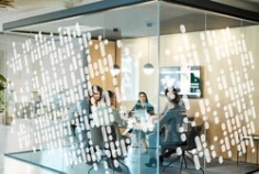 An office conference room with 3M™ Scotchcal™ Clear View Graphic Film IJ8150 and 3M™ Scotchcal™ Optically Clear Overlaminate 8914