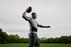 Man throwing football wearing ACE back stabilizer.