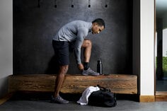 Man putting shoe on over ACE deluxe ankle brace.