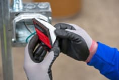 Image of removing the backing of the electrical box insert