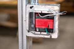 Image of the installation of an electrical box insert in metal box