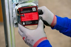 Image of the installation of an electrical box insert in metal box