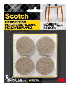 Scotch Floor Protectors in packaging. Four floor protectors are visible in the packaging. A table sits on hardwood flooring.