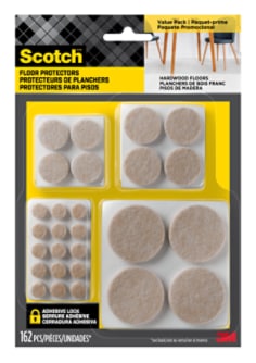 Scotch Floor Protectors in packaging. A variety of sizes of floor protectors are visible in the packaging. Two chairs and a table sit on hardwood flooring.