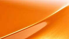 A swatch of 3M™ Wrap Film Series 2080 Gloss Deep Orange