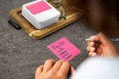 Post it notes dispenser with wife wave design on the sides. one pad of pink pop up notes included 