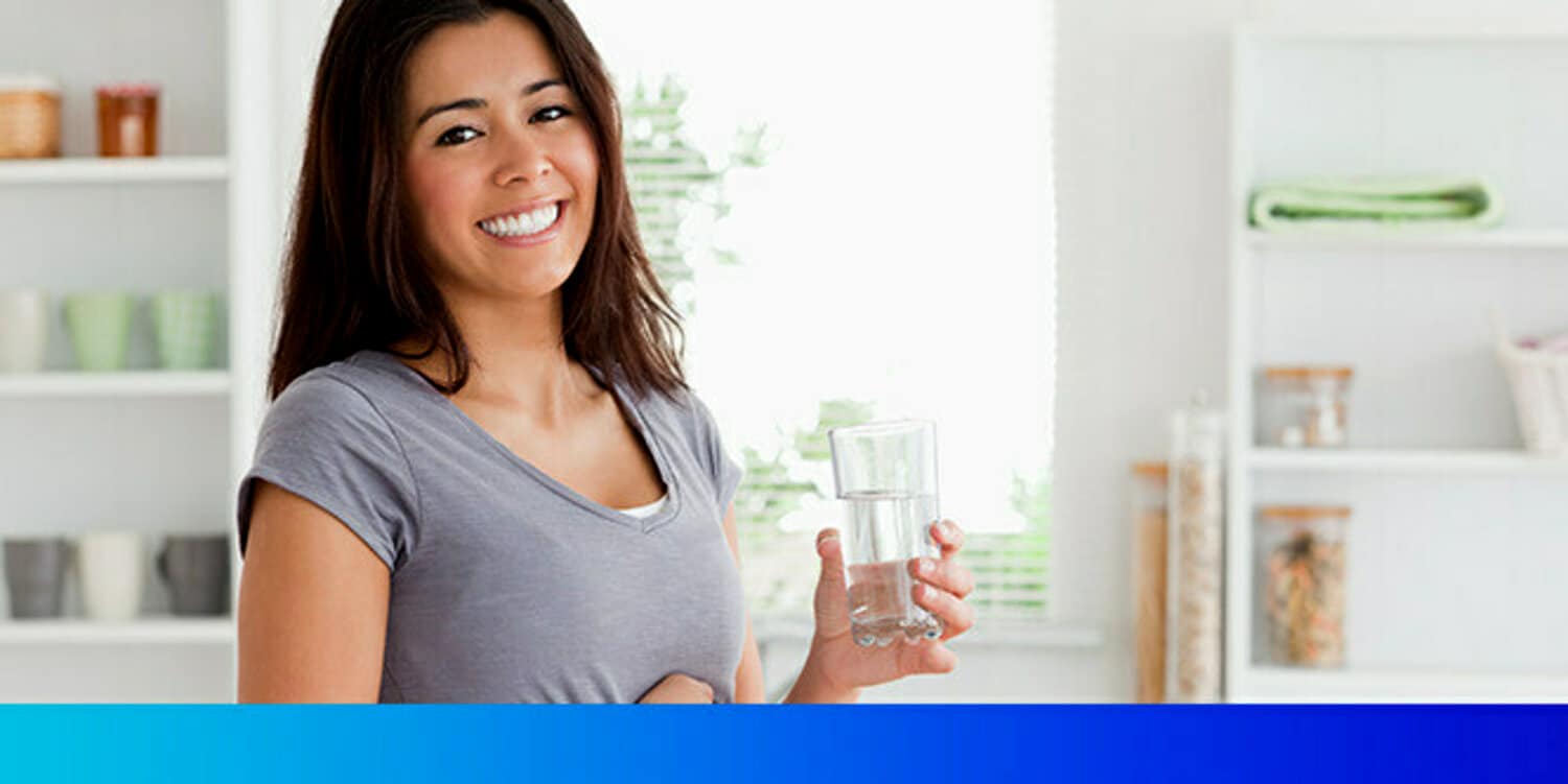 Photo of woman holding a glass of water