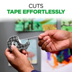 Scotch Stainless Steel Tape Dispenser cuts tape effortlessly.  Image of a person pulling a piece of tape from the tape dispenser with artwork hanging on the wall in the background.