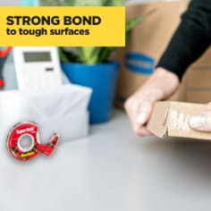 Scotch Super Hold Tape, strong bond to tough surfaces, image of a person taping a small brown corrugate box with Scotch Super Hold Tape.