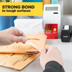 Scotch Super Hold Tape has a strong bond to tough surfaces.  Image of tape being used to seal an envelope. 