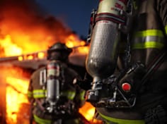 3M Scott Air-Pak XD SCBA worn by firefighters at an exterior nighttime residential fire.