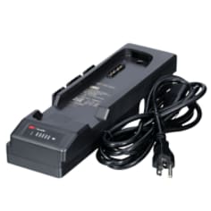 A 3M Versaflo Single Station Battery Charger Kit TR-642N beside power cord