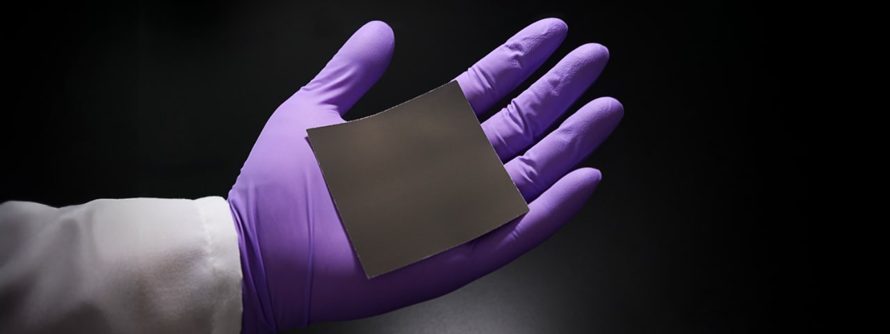 Photo of a gloved hand holding 3M hydrogen iridium catalyst sheet for hydrogen fuel capture