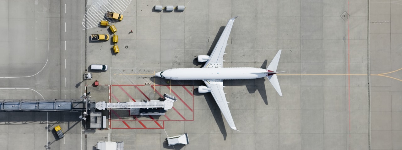 Photo of a commercial airplane parked on an airport tarmac