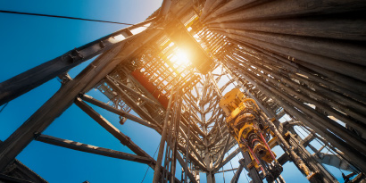 View looking up the tower of a drilling rig.
