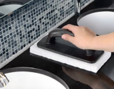 Cleaning commercial restroom with white pad