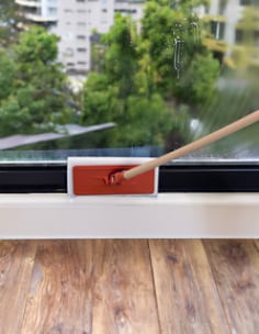 Cleaning glass baseboard with white pad