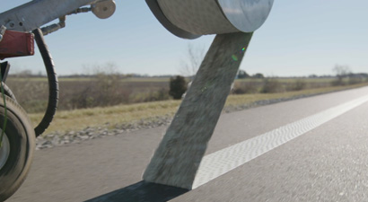 Close-up of white 710IR product removal, tape is spooling onto cart