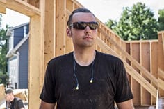 Image of a PRO wearing 3M™ Push-Ins™ Corded Earplugs around their neck on a job site