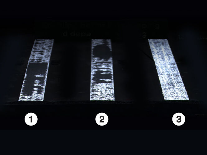Various road markings at night with different compositions of paint, with All Weather Elements as the brightest.
