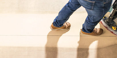 Top down image of the clean path left by an autoscrubber.