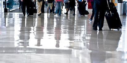 A busy shiny floor walkway with a lot of foot traffic.