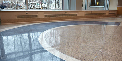 Smooth, polished terrazzo floor with a high-gloss finish inside a building.