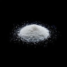 A cluster of 3M Polymer Processing Additive HX 9551 on a dark background
