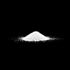 A cluster of 3M Polymer Processing Additive HX 9551 on a dark background