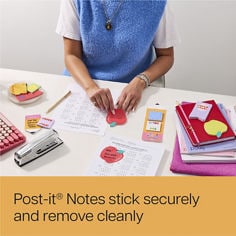 Image of a female handling a apple shaped Post it®, Reader: Post it® notes stick securely and remove cleanly