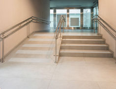 Indoor stairway with handrails featuring 3M Safety-Walk 600 slip-resistant tread in black applied to each stair step
