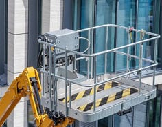 Suspended work basket featuring 3M Safety-Walk 600 slip-resistant tread in black and yellow stripes